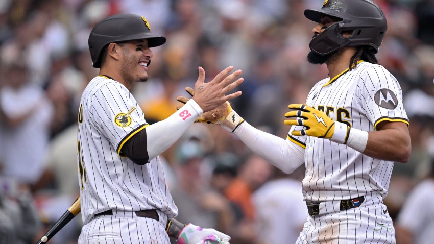 SAN DIEGO, CALIFORNIA – JUNE 21: Fernando Tatis Jr. #23 of the San Diego Padres is congratulated by Manny Machado #13 after hitting a three-run home run against the Kansas City Royals during the seventh inning at Petco Park on June 21, 2025 in San Diego, California. (Photo by Orlando Ramirez/Getty Images)