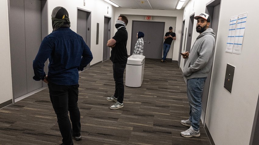 Plainclothes Immigration and Customs Enforcement officers wait in the hallway of a federal courthouse in New York City on Tuesday.