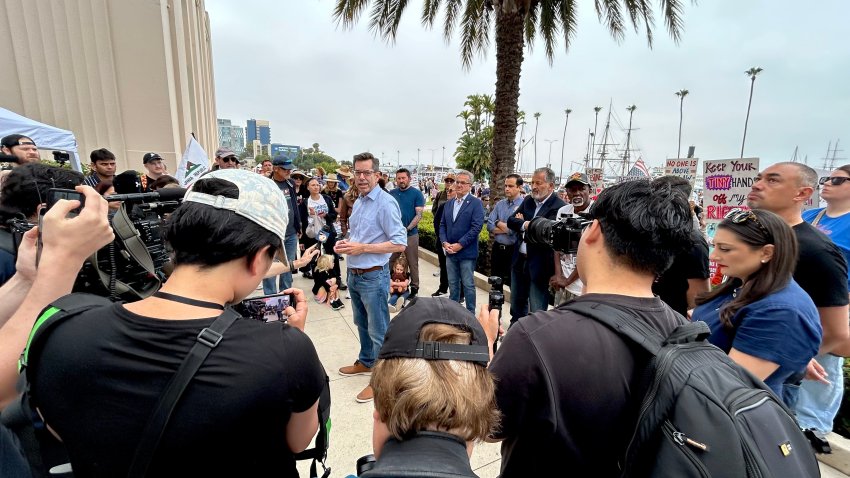 San Diego District 3 Councilmember Stephen Whitburn (center) joined other local politicians and community leaders in a press conference, Saturday morning. The group spoke in support of demonstrators assembled at Waterfront Park, June 14, 2025.