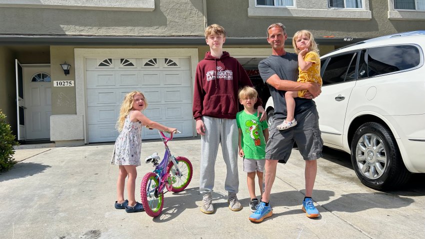 Jared McClurg with four of his children outside their Murphy Canyon home. (starting left) Aurora, 6, Gavin, 17, Harry, 5, and Sloane, 3. June 22, 2025.