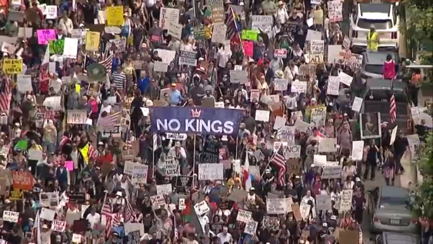 Protesters march downtown San Diego as part of the 'No Kings' Day protest, June 14, 2025.