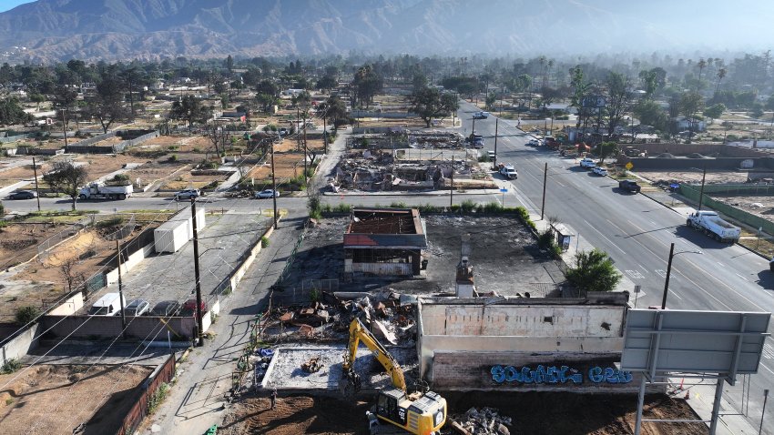 ALTADENA, CALIFORNIA &#8211; JULY 07:  An aerial view of workers clearing a business which burned in the Eaton Fire on July 07, 2025 in Altadena, California. Today is the six month anniversary of the Eaton and Palisades fires which claimed 30 lives and left more than 16,000 structures destroyed. The U.S. Army Corps of Engineers has cleared more than 5,000 properties damaged in the Eaton Fire. (Photo by Mario Tama/Getty Images)