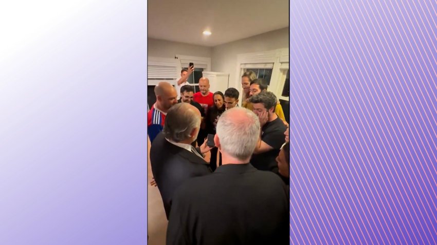 families of Israeli hostages gather around a phone