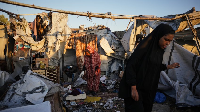 Displaced Palestinians inspect the damage after an Israeli army strike on their tent camp in Deir al-Balah, Gaza Strip, Wednesday, Oct. 29, 2025.