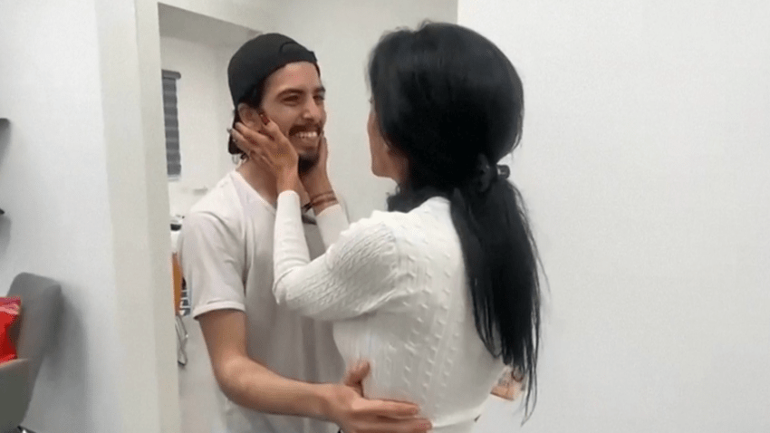 Mother embraces her son after being reunited