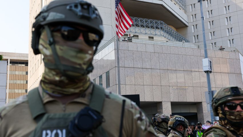 LOS ANGELES, CALIFORNIA – JUNE 13: Federal agents guard outside of a federal building and Immigration and Customs Enforcement (ICE) detention center in downtown Los Angeles as demonstrations continue after a series of immigration raids began last Friday on June 13, 2025, in Los Angeles, California. Tensions in the city remain high after the Trump administration called in the National Guard and the Marines against the wishes of city leaders. (Photo by Spencer Platt/Getty Images)