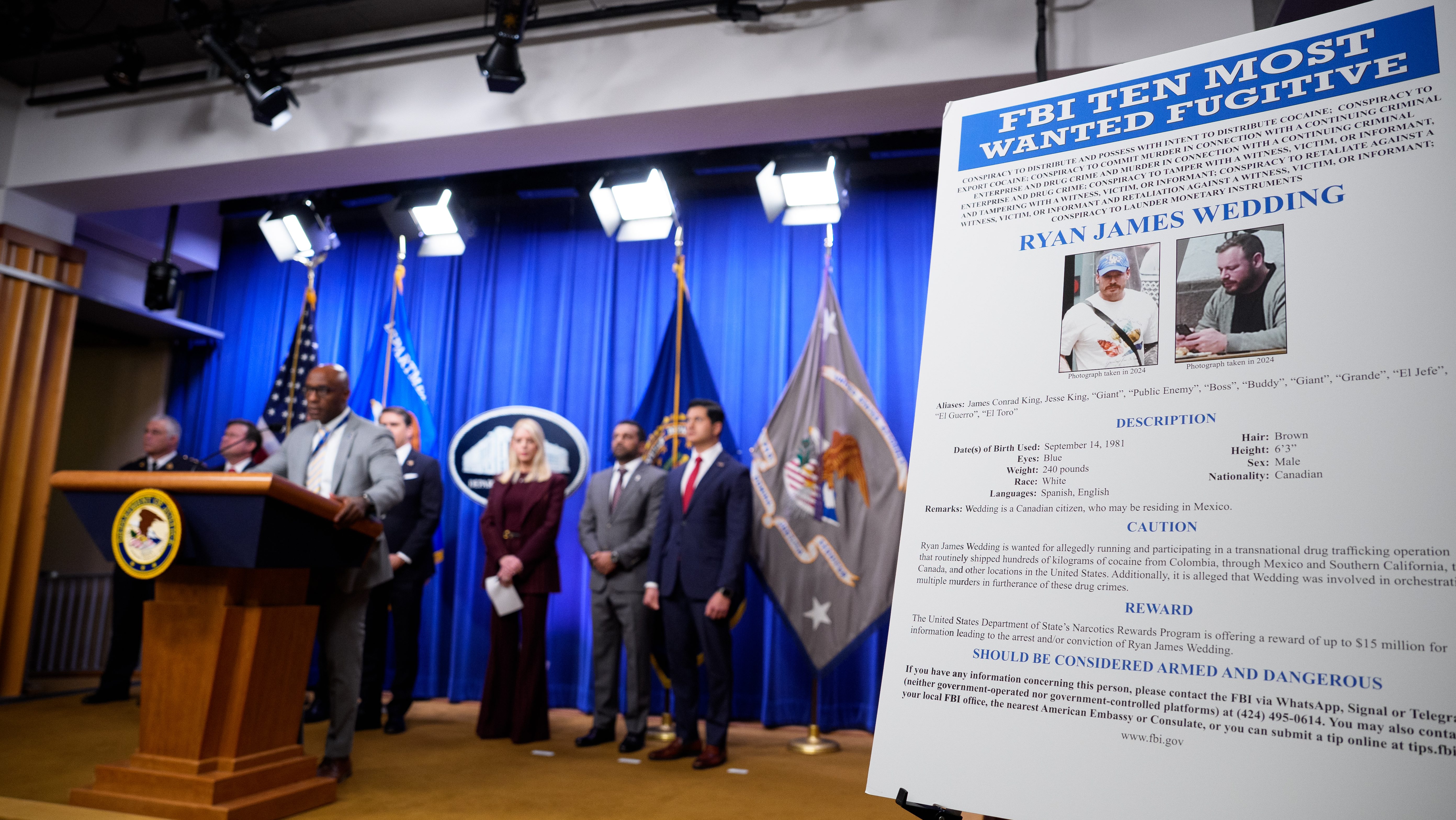 An FBI Ten Most Wanted poster is displayed during a news conference announcing the indictment of a former Olympic snowboarder Ryan Wedding, charging him with murder and money laundering in connection to a drug trafficking organization