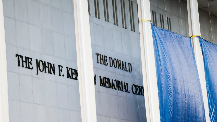 WASHINGTON, DC – DECEMBER 19: Workers adjust the name of the “John F. Kennedy Memorial Center for the Performing Arts” on December 19, 2025 in Washington, DC. The Kennedy Center Board of Trustees voted in what they say was a unanimous decision to rename the facility “The Donald J. Trump and The John F. Kennedy Memorial Center for the Performing Arts”. (Photo by Heather Diehl/Getty Images)