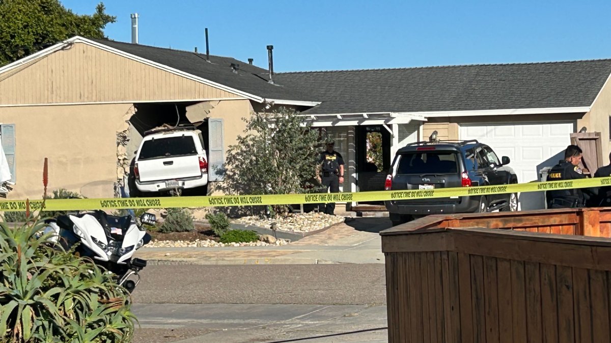 Woman found dead after truck crashes into Bay Park home; husband detained