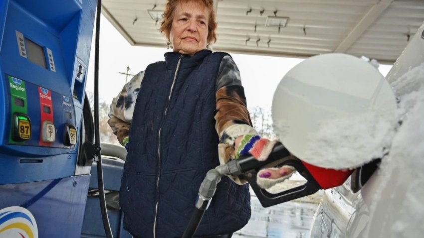 A customer pumps gas at a gas station., on Dec. 3.
