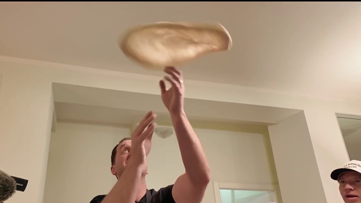 Medal-worthy? Steven Luke tests out his pizza-making skills in Milan