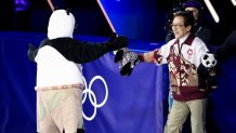 Mikhail Shaidorov of Team Kazakhstan greets Jackie Chan after his Men Single Skating routine during a Figure Skating Exhibition Gala.