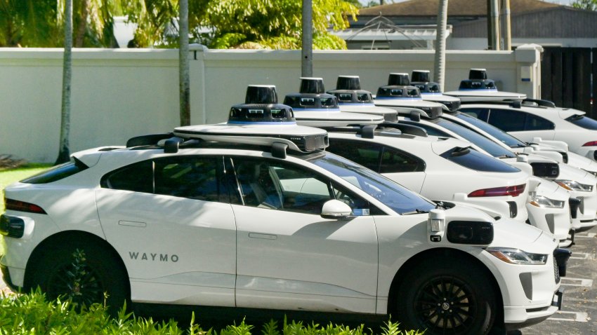 A row of self-hail autonomous driving taxi cabs owned and operated by Waymo as seen in Miami, Florida, on Jan. 4, 2025.