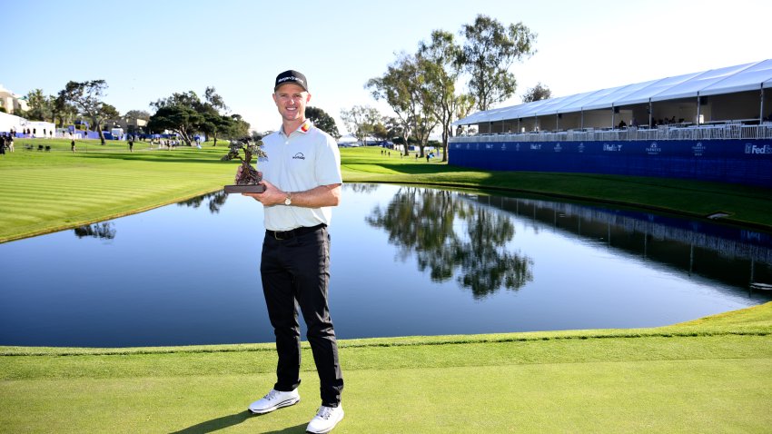 LA JOLLA, CALIFORNIA – FEBRUARY 01: Justin Rose of England poses with the trophy after putting in to win on the 18th green during the final round of the Farmers Insurance Open 2026 at Torrey Pines South Course on February 01, 2026 in La Jol