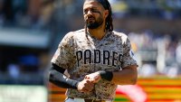 SAN DIEGO, CALIFORNIA – JUNE 28: Fernando Tatis Jr. #23 of the San Diego Padres holds his hand after being hit by a...