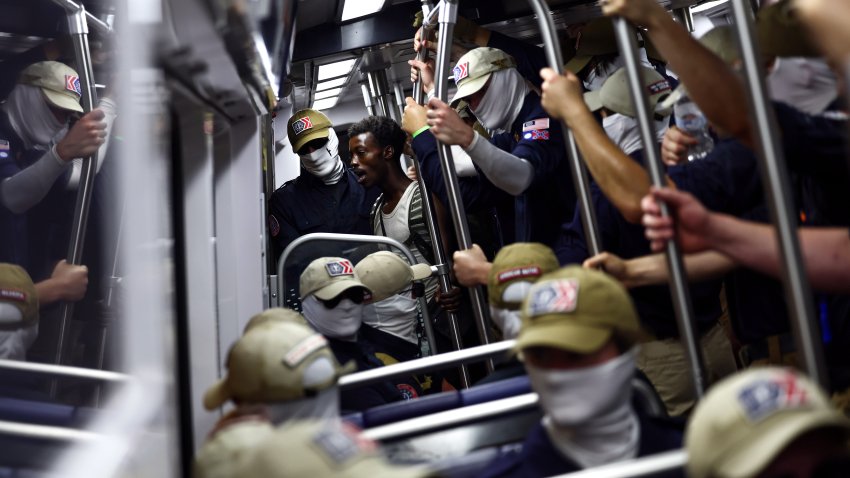 WASHINGTON, DC – JULY 04: A passenger (C) looks on as members of the white supremacist group Patriot Front ride the Washington Metro on July 04, 2026 in Washington, DC. Numerous events, activities, and fireworks are planned in celebration of America’s 250th Anniversary.  (Photo by Finn Gomez/Getty Images)