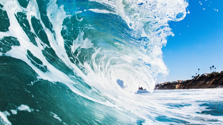 Close up of rolling wave and foamy sea in San Diego.