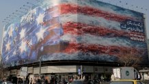 TEHRAN, IRAN - JAN 26, 2026: A huge banner displayed in Revolution Square depicts a missile attack on board a US Carrier painted in US flag colors in the Persian Gulf on January 26, 2026 in Tehran, Iran. (Photo by Kaveh Kazemi/Getty Images)