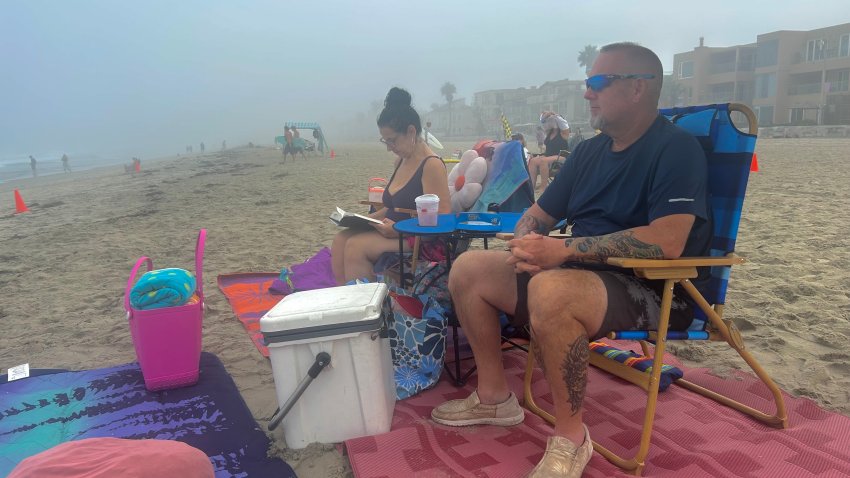Jessica Urban and her husband, Tim, visited Mission Beach, Saturday, traveling from their home in Phoenix to escape triple digit temperatures, San Diego, Calif., August 29, 2026.