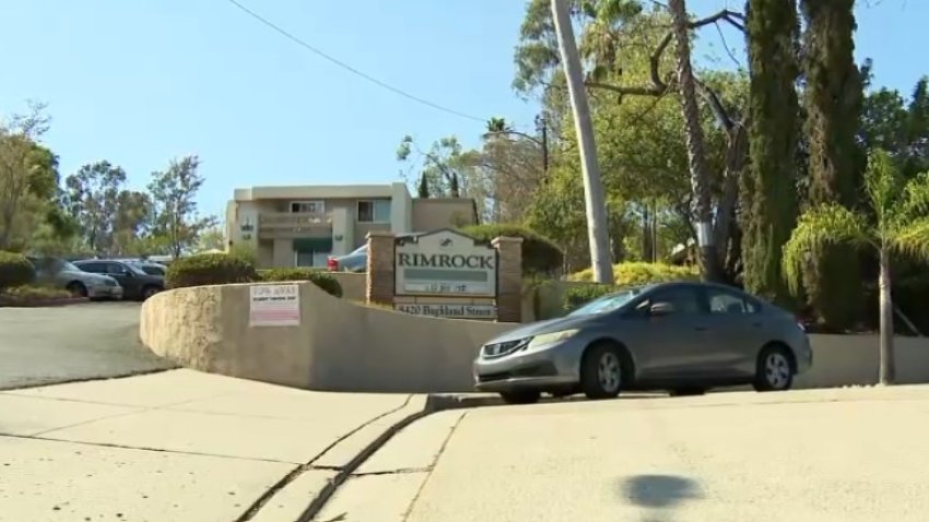Image taken outside a La Mesa apartment complex where a man was arrested after a bullet traveled through a shared wall into a neighboring apartment and struck an uninvolved person.
