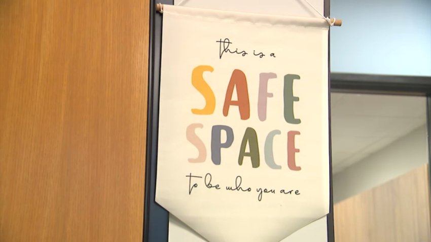 A sign in colorful letters reads "This is a Safe Space to be who you are." September 21, 2026.