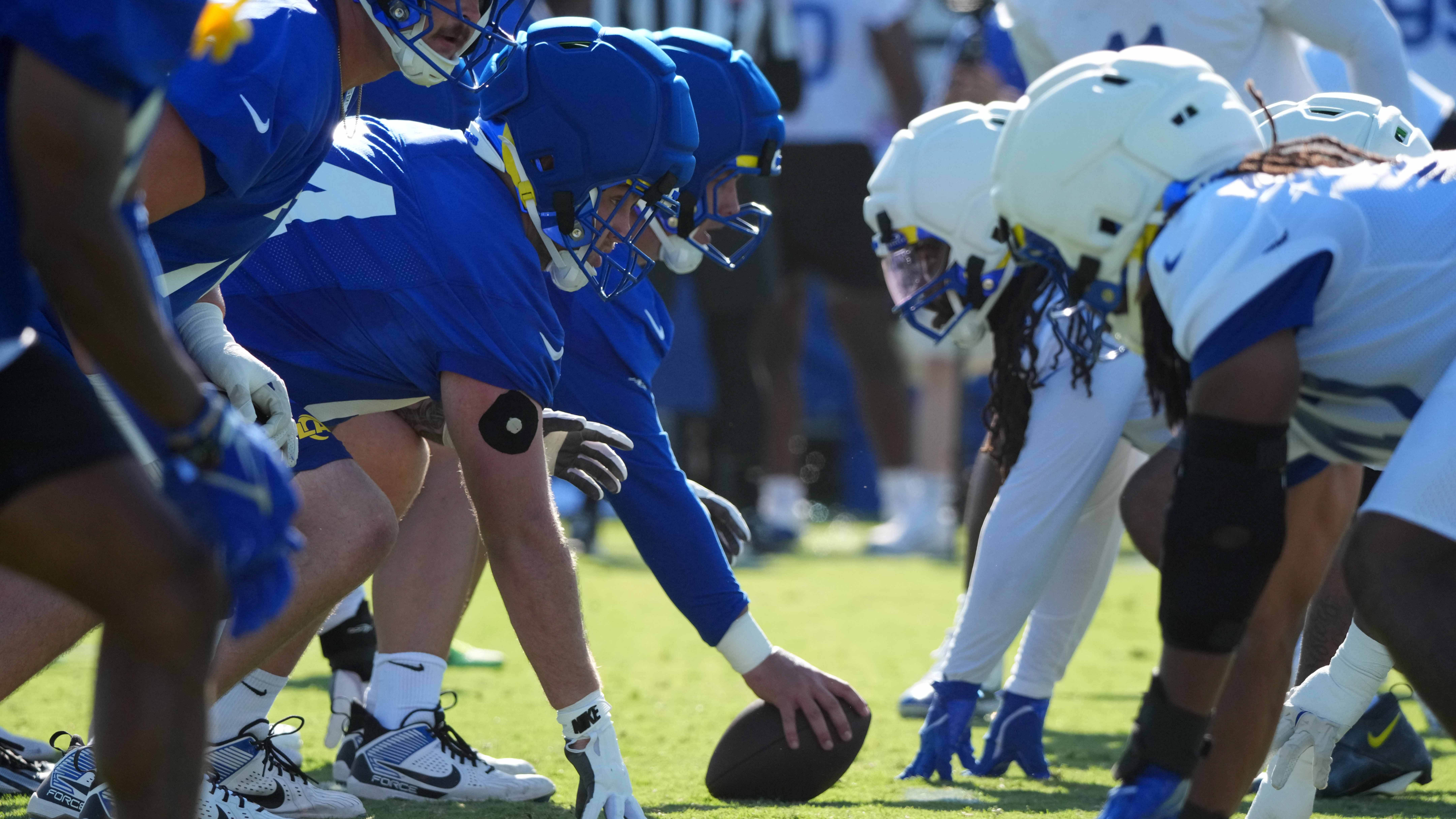 Helmets with Guardian helmet caps at the line of scrimmage