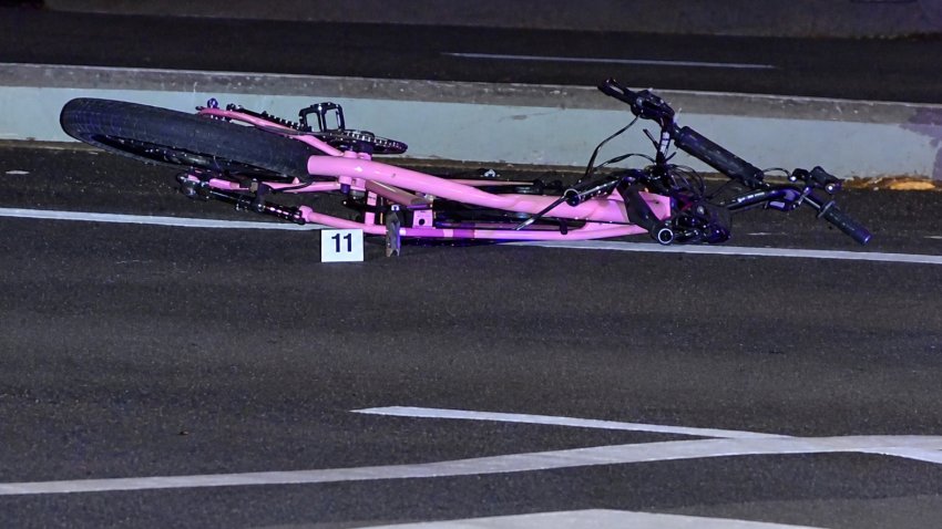 The damaged e-bike lays on Balboa Ave after the 14-year old boy riding it was hit by a car and later died, September 12, 2026.