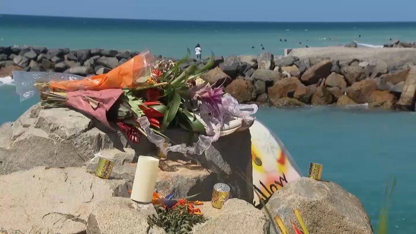 A bouquet of flowers sits on a rock next to the ocean. September 17, 2026.