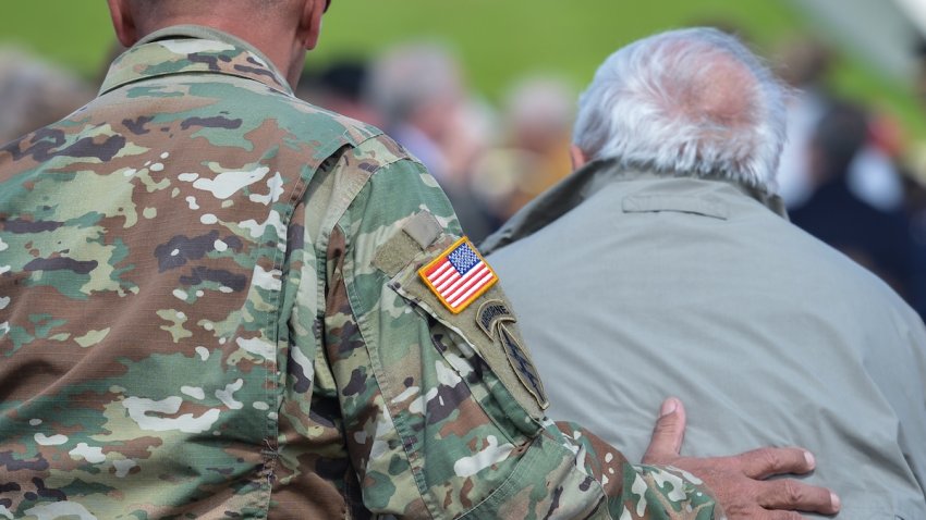 A member of the U.S. Army helps a U.S. D-Day Veteran on Tuesday, June 6, 2017, in Utah Beach, Pouppeville, La Madeleine, France.
