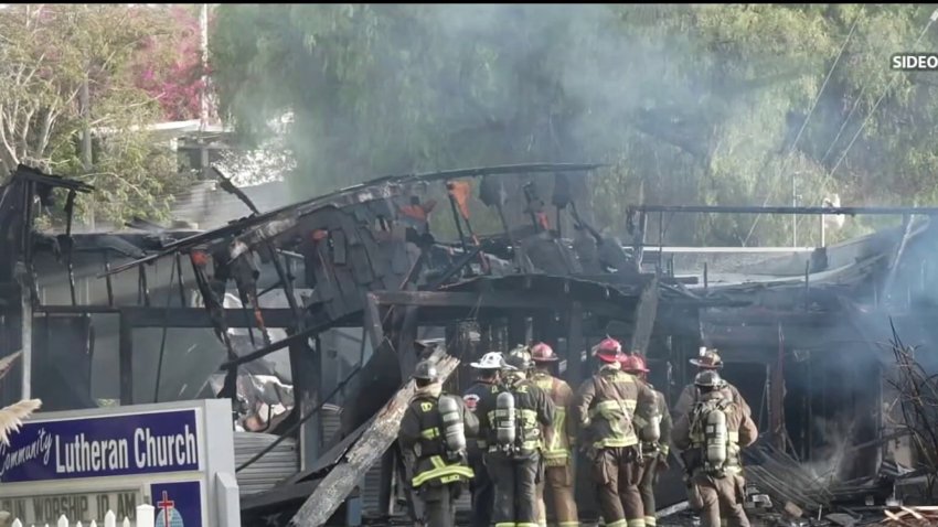 A burned building is surrounded by firefighters. September 8, 2026. Credit: Sideo.tv