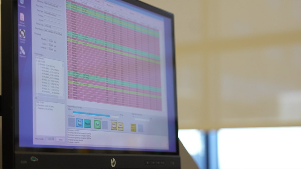 A mail-in ballot machine at the San Diego County Registrar of Voter's Office shows errors that were quickly corrected, resulting in ballots being re-scanned successfully.