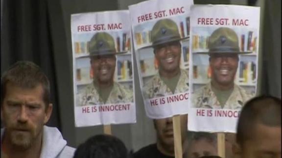 Supporters March Outside Hearing for Boot Camp Instructor